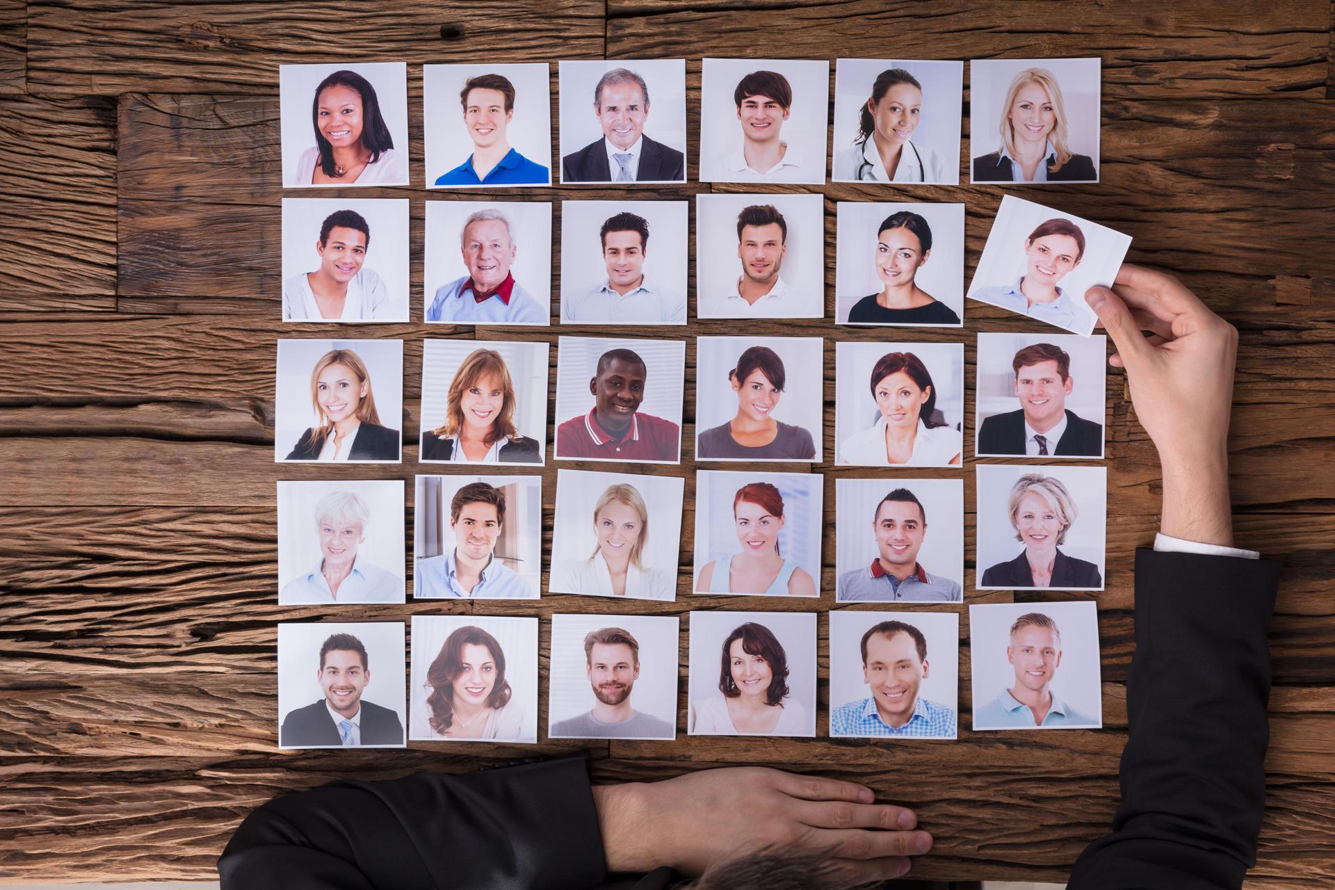 Businessperson Choosing Photograph Of Candidate
